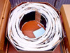 Top-down view of open Uni-Solar ePVL-144T carton showing 30 flexible solar panels rolled and coiled inside