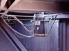 Trane CGAF-C20 interior condenser fan motor — motor mounted under fan deck with wire leads and protective cage guard, surface rust on mounting bracket