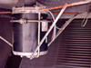 Trane CGAF-C20 condenser fan motor close-up — black cylindrical motor body with nameplate label, surface rust on fan guard and mounting hardware