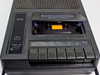 Bell & Howell 3169A cassette door open — showing tape transport mechanism, capstan, pinch roller, and read/write head with transport buttons below