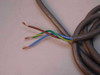 Hardwired input power cable of Digital 874-E power supply showing bare-end brown, blue, and green-yellow conductors