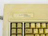 Zenith Data Systems keyboard close-up of top-left corner showing Zenith Data Systems badge, F1–F4 function keys, and Esc/Tab keys with yellowing and surface grime