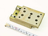 Schneeberger miniature linear slide rear-left view with tape measure confirming approximately 2.5 inch width, yellow-green anodized base plate and recirculating ball carriage blocks visible on left side
