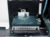 Titertek Zoom microplate stage area showing dispense head label, plate platen, and 96-pin stainless steel wash manifold from front