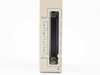 Sharp JW-34NC – bottom edge connector view showing COM.AB and COM.CD terminals with 32-point I/O wiring positions