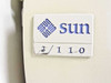 Sun Microsystems 3/110 front nameplate badge showing Sun logo and model number with yellowed plastic surround