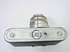 Argus C-Four bottom view showing film door latch marked OPEN, bottom plate with scuffs and wear, and serial number area