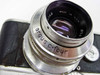 Close-up of Argus C-Four lens barrel showing 'argus c-four' engraving and 'MADE IN U.S.A.' marking on Coated Cintar f/2.8 lens