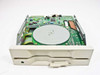 Canon MD5501 floppy drive — top-open view showing spindle motor hub, read/write head assembly, and green PCB