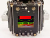 Front-on view of LCD projector prism block showing dichroic optical coatings reflecting red, green, yellow, and blue light through the prism