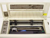 HP 2631B interior with lid open — print head carrier, platen rod, and print mechanism visible with dust and debris on ribbon area