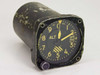 Kollsman MB-2 Pressure Altimeter front three-quarter view showing black dial face with yellow numerals and ALT label, yellow pointer hands, Kollsman window at 3 o'clock, and heavily worn black housing with paint loss
