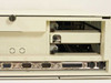 IBM PS/2 Model 56 rear I/O port strip detail showing two DB-9 serial ports, one 10-pin connector, one DB-25 parallel port, and two mini-DIN PS/2 ports, with MCA expansion slot bay open