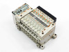 SMC EX120-SSH1 serial interface unit and VQ1200-5 valve manifold assembly – angled rear-right view showing full assembly profile and DIN rail mount