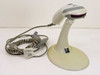 Metrologic MS9540 Voyager CG barcode scanner in stand with coiled USB converter cable laid out in front