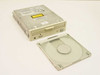 Toshiba XM-3401B 4x SCSI CD-ROM drive – top-angled view with caddy open beside the drive showing caddy tray and drive body with dust on top