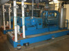 SIHI LPH 85353 vacuum pump skid — full side view installed in facility, showing blue skid, motor, pump body, piping connections, and separator vessel