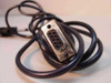 DB9 male 9-pin connector end close-up showing pin holes and metal shell with cable