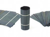 Solopower SP3 flexible CIGS solar cells — rolled cylinder center with multiple fanned cell stacks flanking, product overview shot
