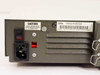 Rear panel closeup showing IEC 320 C14 power inlet, 115V voltage selector switch, power rocker switch, serial number label, and model/FCC ID label