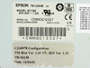 Epson TM-U200B M119B bottom label showing model number, 24V–34V 1.2A power rating, serial number CMMG012327, Seiko Epson Corp., Made in China, CE and UL marks, and C236978 configuration sticker with TM Bios Ver. 1.02 NV / IDN Ver. 1.15 / TR-06138 / Date 12/04/01