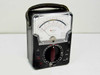 Triplett 630-NA three-quarter front view in black leatherette carry case with top carry handle — meter face and selector dial visible
