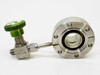 Nupro SS-4H angle needle valve with green knurled knob and NUPRO flow-arrow label, connected to CF DN40 Conflat flange with black o-ring seal — side view