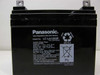 Panasonic LC-LA1233P battery label close-up showing model number, 12V 33Ah/20HR rating, charge voltage specs, and Made in Mexico text