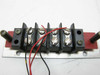 Thermco 4104 contact/wiring block close-up – front view showing screw terminals on black housing mounted on red PCB and aluminum bracket with probe stubs