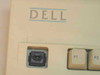 Dell AT101 keyboard – close-up of upper-left corner showing old Dell logo with blue accent lines and mechanical key switch detail