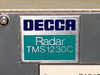 Close-up of Decca Radar TMS1230C nameplate label on display console, showing brand name and model number