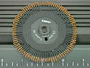 Juki 176-0A0 Courier 10 daisy wheel print element shown against ruler for scale, with visible character petals