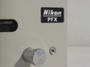 Nikon PFX shutter body close-up showing model name plate and large aluminum control knob with small port to the right
