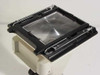 Nikon PFX 4x5 back shown open from above, revealing large Fresnel ground glass screen and black film holder frame