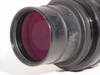 Angled front view of Nikon Printing-Nikkor 105mm f/2.8 showing magenta-coated front element and barrel with light scuffing