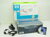 HP PSC 1350 all-in-one printer with original box, power adapter, USB cable, and software CD laid out on white background