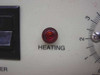 Terra Universal NAPCO 5404-00 Vacuum Nitrogen Oven — close-up of illuminated red HEATING indicator lamp and partial view of temperature dial