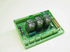 Relay PC Board 280295-001 top angled view showing four relays, green DIN rail housing, screw terminal blocks, and DB25 connector