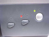 Epson Stylus Photo 1280 front panel control buttons — ink/paper indicator light lit red, power LED lit green, power button and function buttons visible