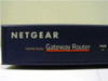 Netgear RT311 Gateway Router — close-up of front left panel showing NETGEAR branding, 'Internet Access Gateway Router' label, and lit PWR LED