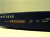 Netgear RT311 Gateway Router — angled front-left view showing PWR, TEST, and LNK/ACT LED indicators
