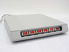 Power Center PC-006 front view showing six labeled red lighted toggle switches: AUX2, AUX1, Printer, Monitor, Computer, Master — all illuminated
