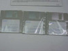 Three IBM DOS 5.0 3.5-inch floppy diskettes in clear sleeves labeled 'IBM DOS Diskette 1 of 3', '2 of 3', and '3 of 3' with version 5.02 visible