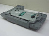 HP C8236A paper cassette — top-down view showing feed mechanism, green guide components, and barcode label