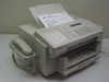 HP C2136A FAX-310 facsimile machine front view with handset, ADF loaded with Windows XP printer test page, and paper output tray