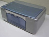HP PSC 1315xi all-in-one printer — front three-quarter view showing blue scanner lid and paper tray