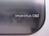 Close-up of Epson Stylus C60 model name badge on dark top cover
