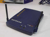 Netgear ME102 802.11b wireless access point — top and front panel view showing NETGEAR logo, model label, power and activity LEDs, and single external antenna