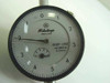 Mitutoyo 2805-10 dial indicator face close-up showing 0.0001"–0.050" range, model number, and 6 Jewels marking