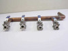 Nibco 4-zone chilled water manifold – three-quarter rear view showing valve spacing and 90-degree copper elbow at left end